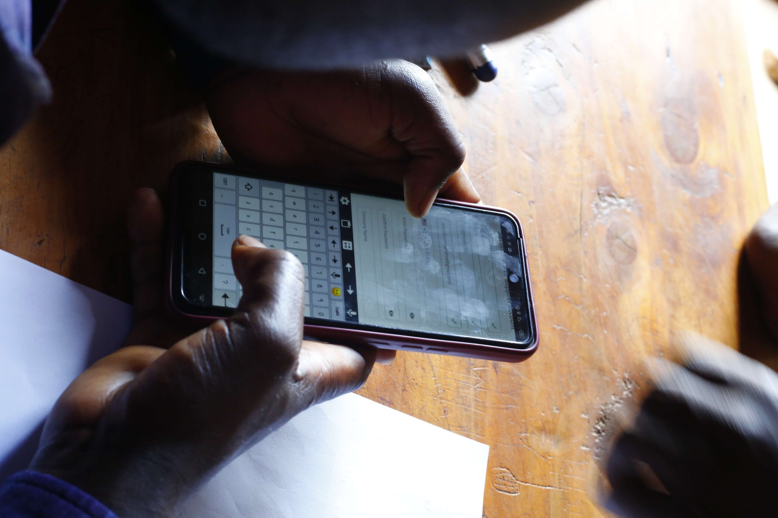 Farmer entering data on smartphone