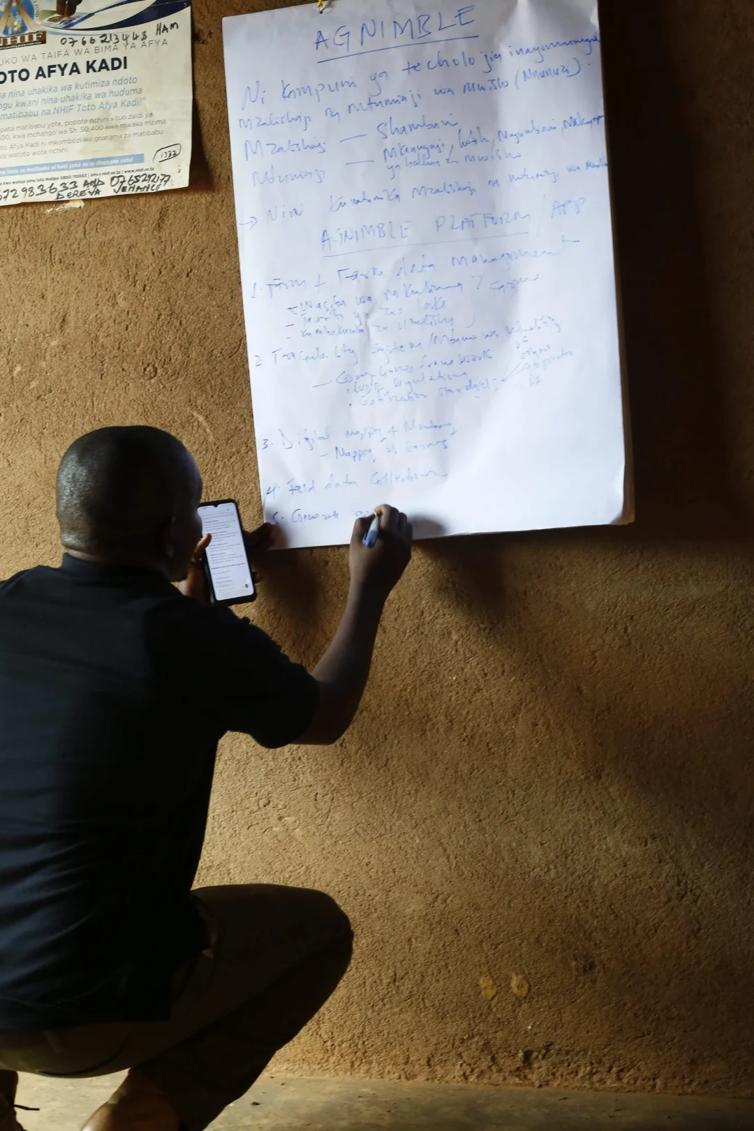 Field staff collecting mobile data as part of a coffee sustainability and digital inclusion program